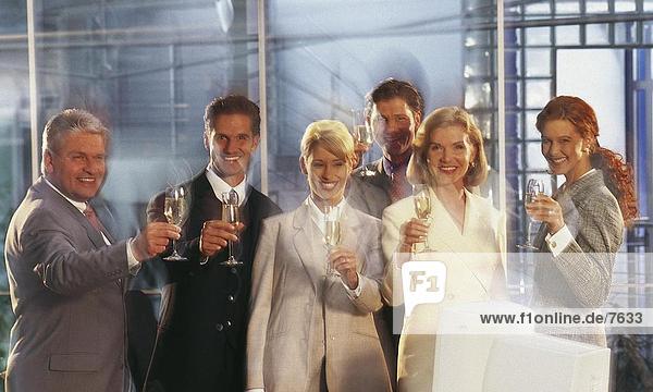 Portrait of group of business executives holding champagne flutes