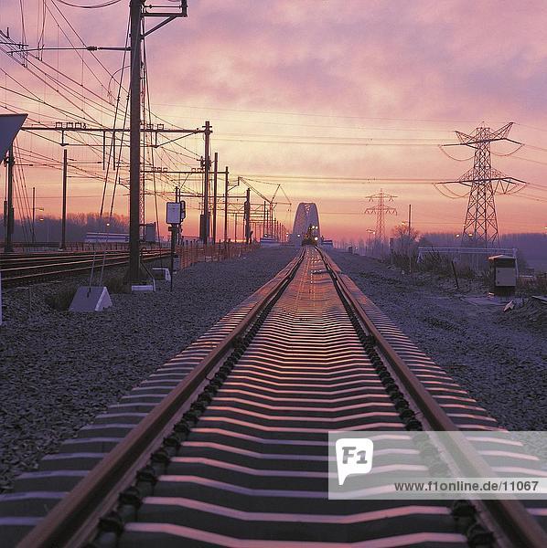 Electricity pylons along railroad tracks  Diemen  Netherlands