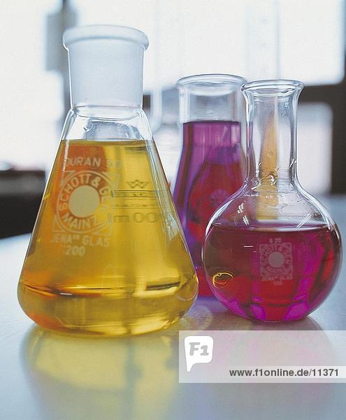Close-up of flasks with colored liquids