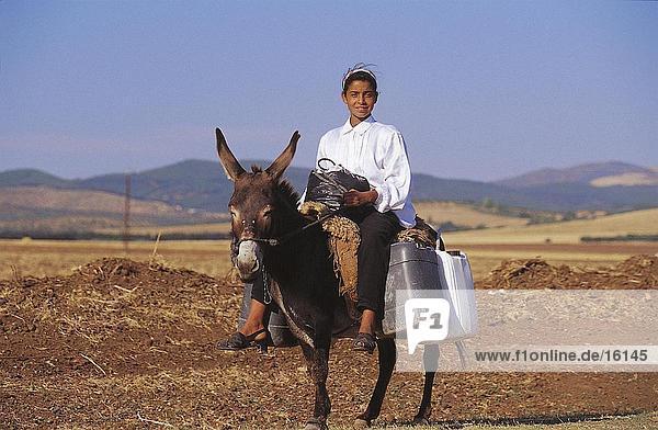 Woman riding donkey on field  Tabarka  Tunisia  North Africa