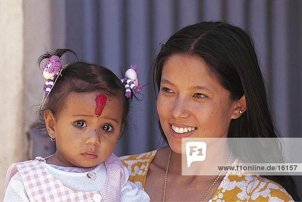 Close-up of woman carrying her daughter  Nepal
