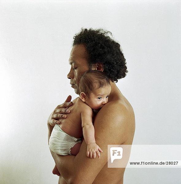 Side profile of man carrying baby