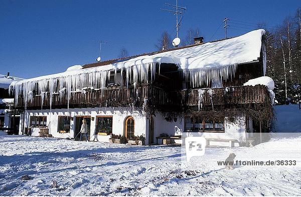 Facade of snow covered farmhouse Bavaria Germany