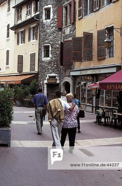 Rear view of tourists on shopping road  Annecy  France