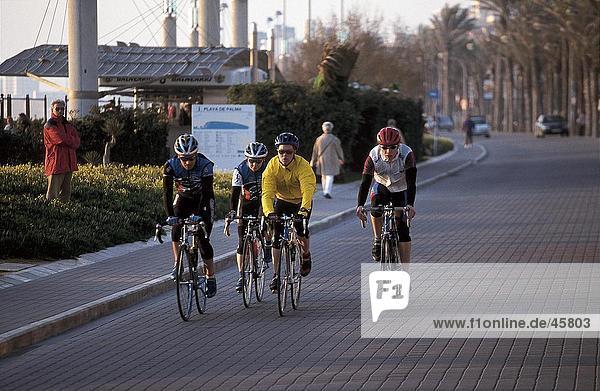 Cyclists in action on promenade  Platja de Palma  Mallorca  Balearic Islands  Spain