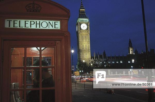 Person using public telephone in booth  Big Ben  London  England