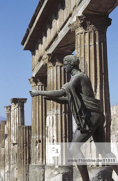 Statue in front of columns  Pompeii  Naples  Campania  Italy