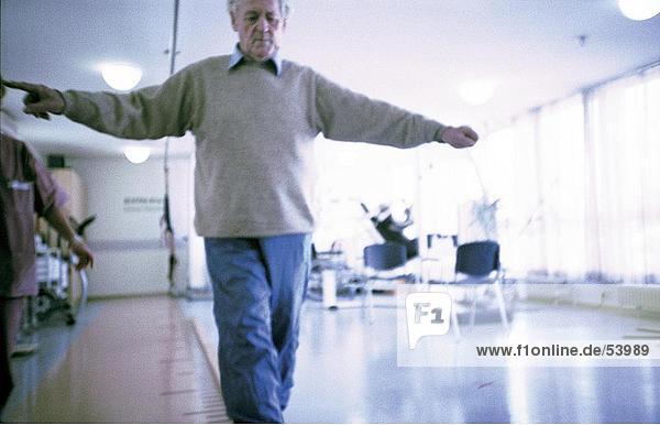 Senior man exercising in rehabilitation centre