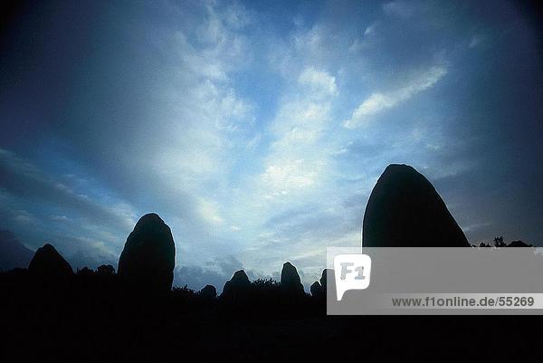 Silhouette of menhir stones at dusk  Carnac  Brittany  France