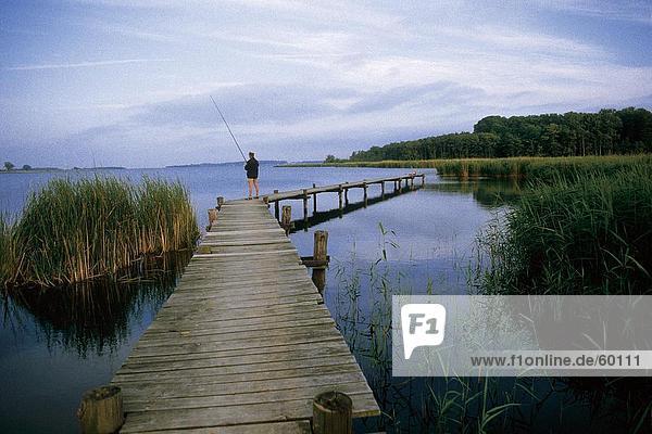 Man standing on footbridge