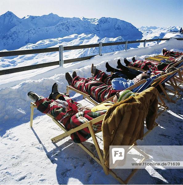 10105301  spare time  skiing area  terrace  person  tourist  solar bath  browning  sun  winter sports  sport  Alps  mountains