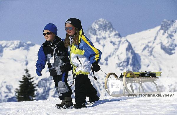 10644433  alpine  Alps  mountains  spare time  boy  child  children  boy  girl  sledge  sledges  sledge  sledge  sleigh  pulli