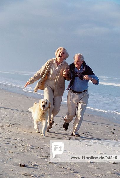 Seniors. Couple. Beach. Pet. Dog