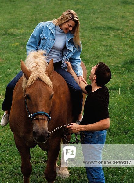 Couple. Outdoors. Horse riding