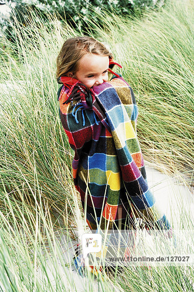 Girl wrapped up in a checked blanket
