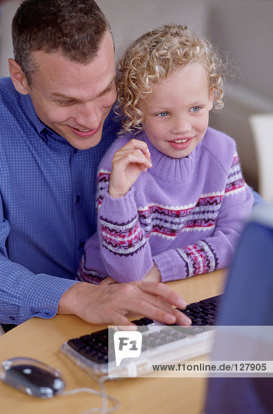Vater und Tochter am Computer