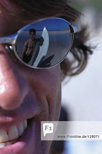Surfer reflected in sunglasses