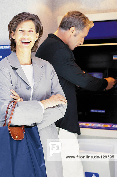 Man and woman at cash machine
