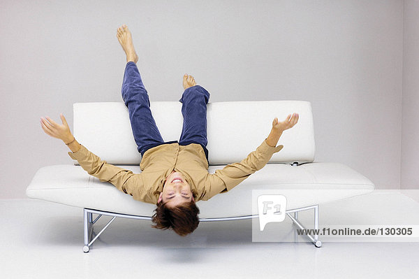 Mann auf modernem Sofa liegend