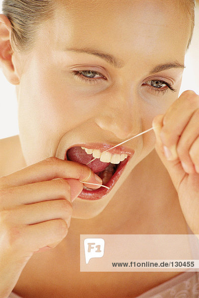 Frau flossing Zähne