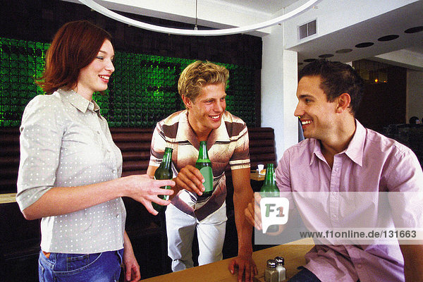 Men and woman having drink at bar