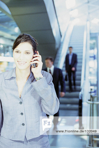Businesswoman with cellphone at airport