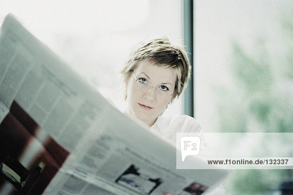 Businesswoman reading paper