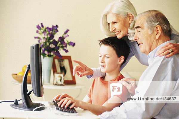 Grandparents and grandson using computer