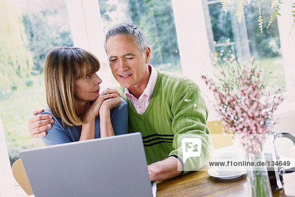 Man and woman using laptop computer
