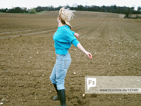 Woman dancing in a field
