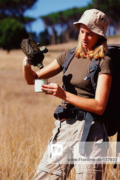 Woman having a drink on a safari