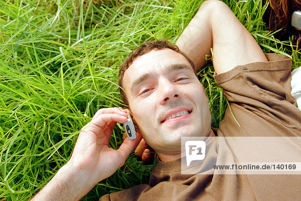 Man using mobile phone in field