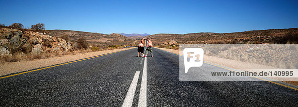 People mooning on desert road