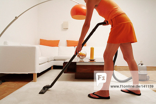 Young woman hoovering