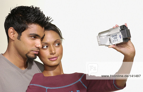 Couple using video camera