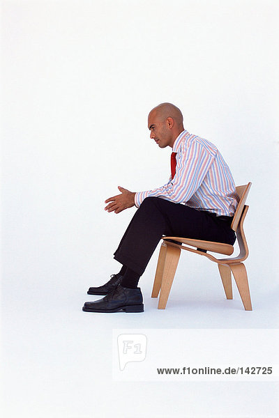 Businessman sits thinking