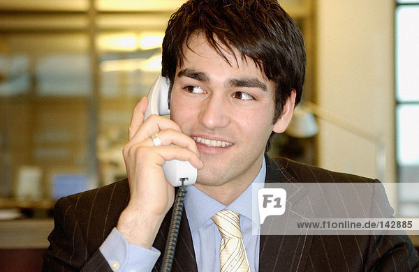 Businessman using telephone