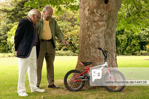 Senior men looking at bicycles