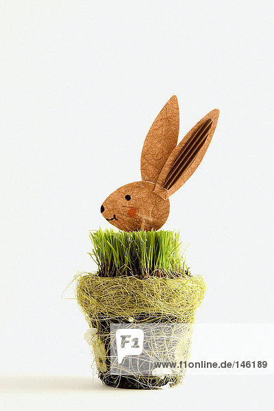 Wooden rabbit in grass