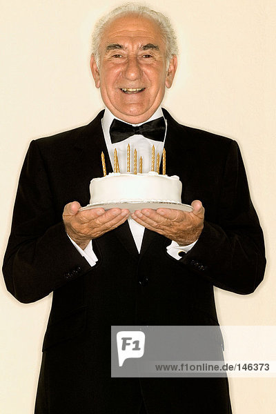 Älterer Mann mit Geburtstagskuchen