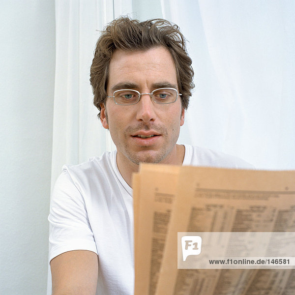 Man reads financial pages