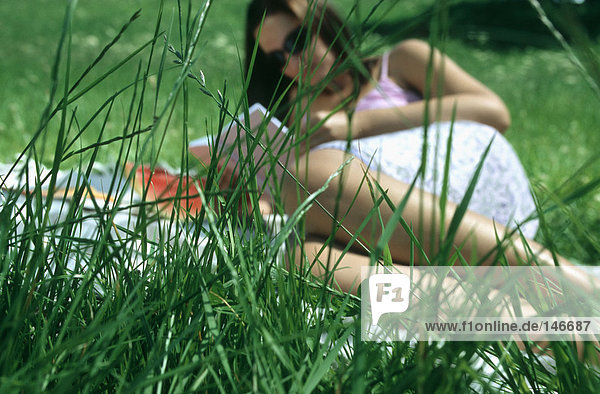 View of woman through grass