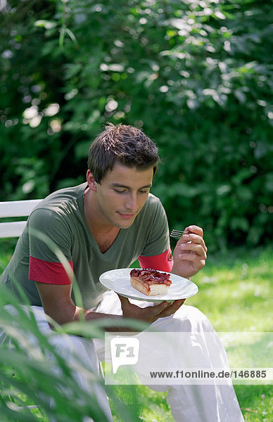 Young man eating dessert