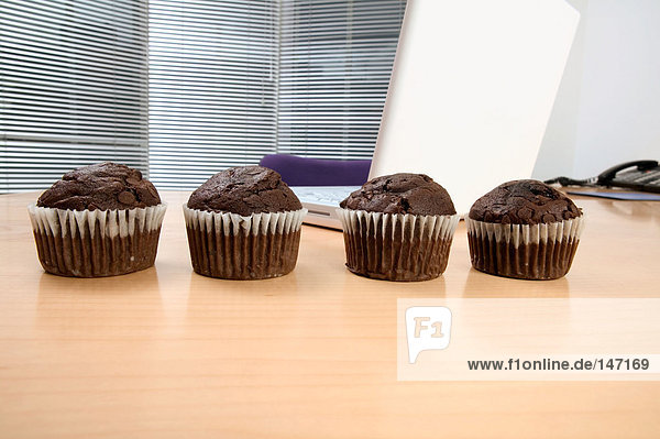 Chocolate muffins on a desk
