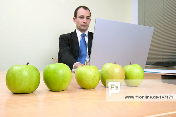 Businessman with apples on desk