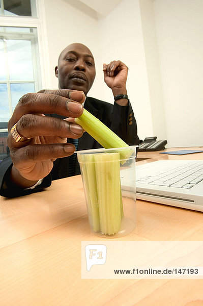 Businessman having celery