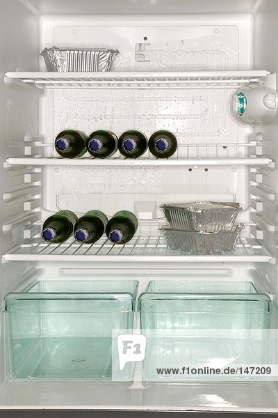 Fast food and beer bottles in a refrigerator
