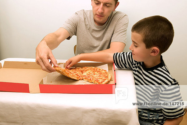 Father and son having pizza