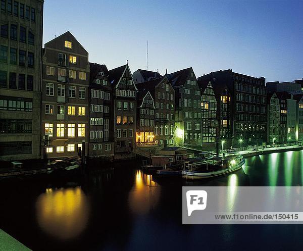 Reflection of buildings in river at dusk  Nikolaifleet  Hamburg  Germany