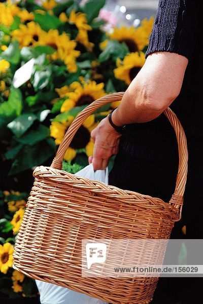 Woman carrying a wickerwork basket